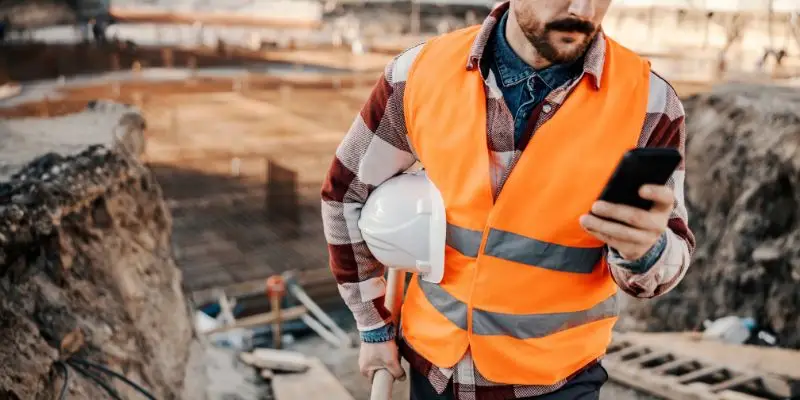 A construction worker stand above a mine site