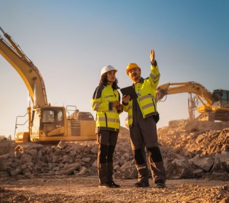 Two individuals discuss a wear part inspection on a mining jobsite.