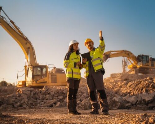 Two individuals discuss a wear part inspection on a mining jobsite.