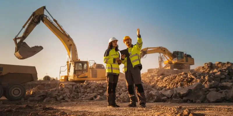 Two individuals discuss a wear part inspection on a mining jobsite.