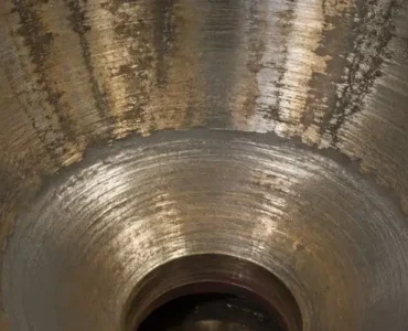 Close-up of cone crusher liners showing wear patterns and surface condition inside the crushing chamber.