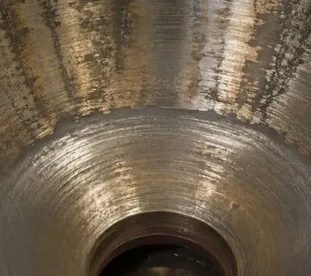 Close-up of cone crusher liners showing wear patterns and surface condition inside the crushing chamber.