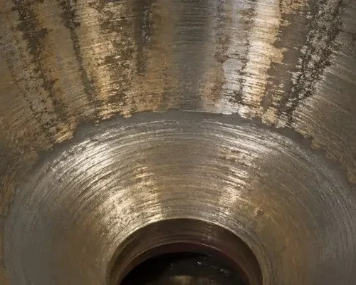 cone crusher liners Close-up of cone crusher liners showing wear patterns and surface condition inside the crushing chamber.