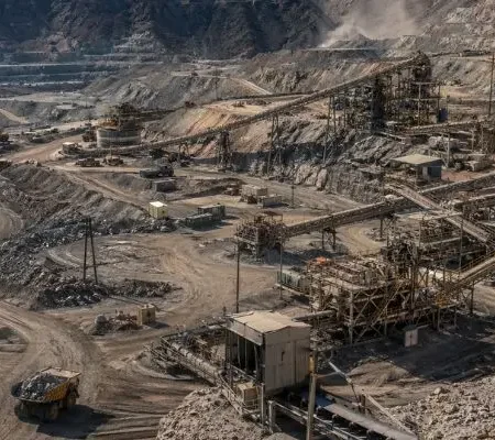 Large open pit mining site with crushing plant and equipment used for mining crusher parts processing