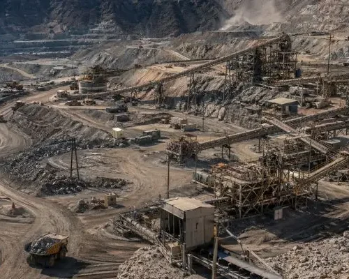 Large open pit mining site with crushing plant and equipment used for mining crusher parts processing