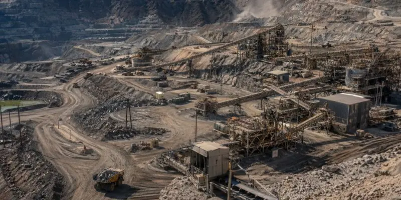 Large open pit mining site with crushing plant and equipment used for mining crusher parts processing