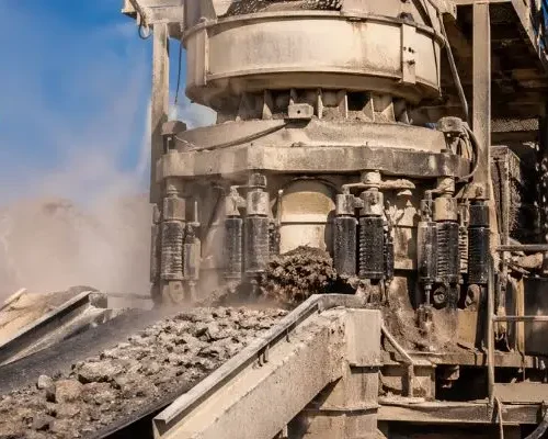 Cone crusher processing material with custom crusher parts for mining in active quarry operation