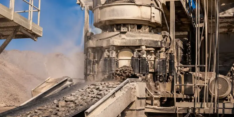 Cone crusher processing material with custom crusher parts for mining in active quarry operation